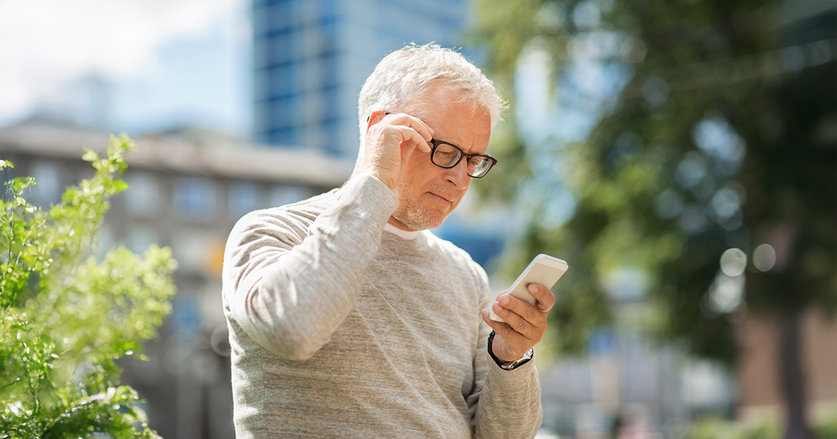 man kijkt op zijn mobiel