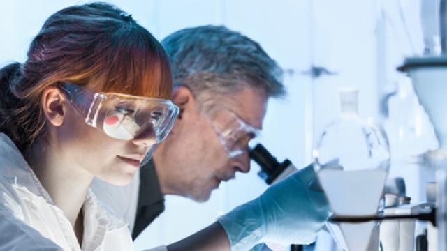 Onderzoekers met reageerbuizen en microscopen