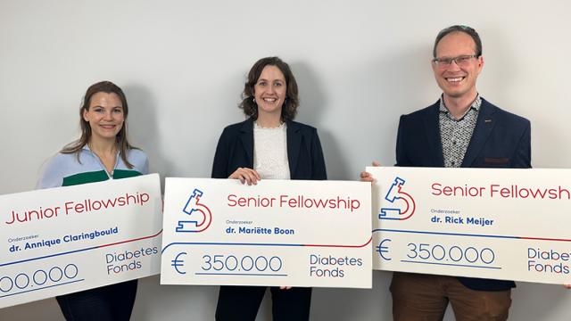 Drie fellows met cheque voor hun onderzoek