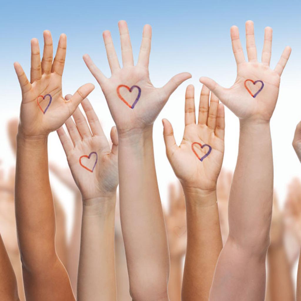 Veel handen in de lucht met een hartje erop, voor wereld diabetesdag