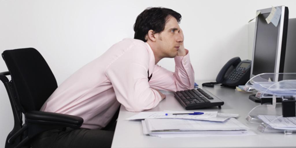 Man hangt voor de computer aan bureau