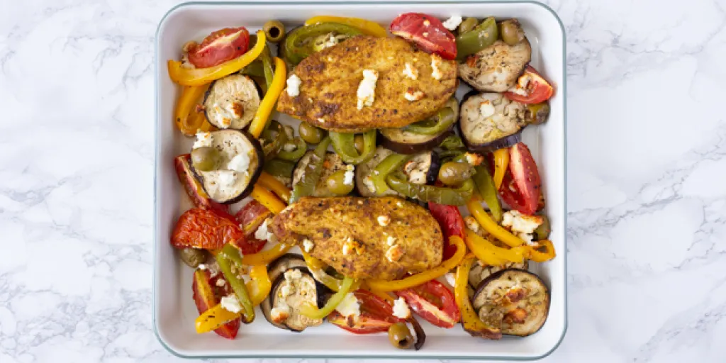 Foto ovenschaal met kruidige kip, paprika en feta