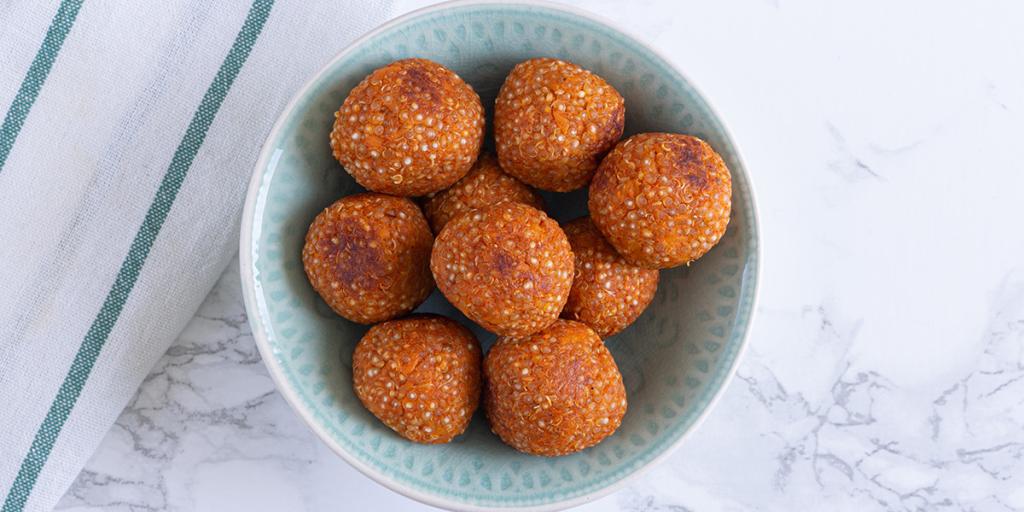 Hartige balletjes van quinoa in een lichtblauw schaaltje