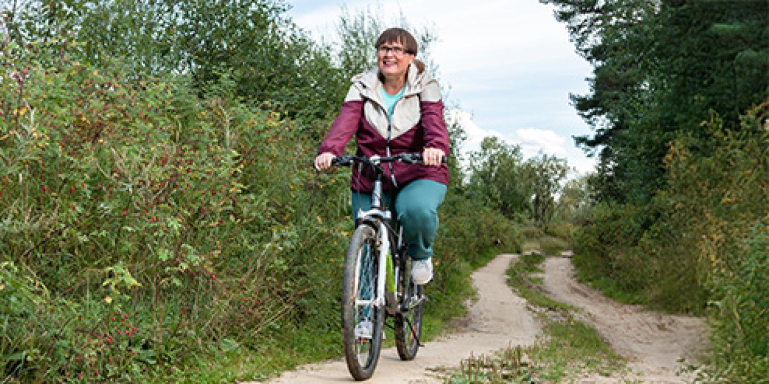 Vrouw fietst door de natuur